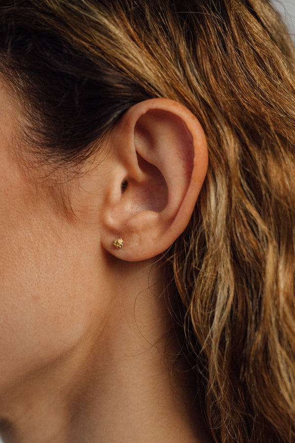 Recycled 18K yellow gold stud earrings, pavé set with brown diamonds and yellow sapphires. Compact, textured design handcrafted in Bali with stones set in Bangkok.