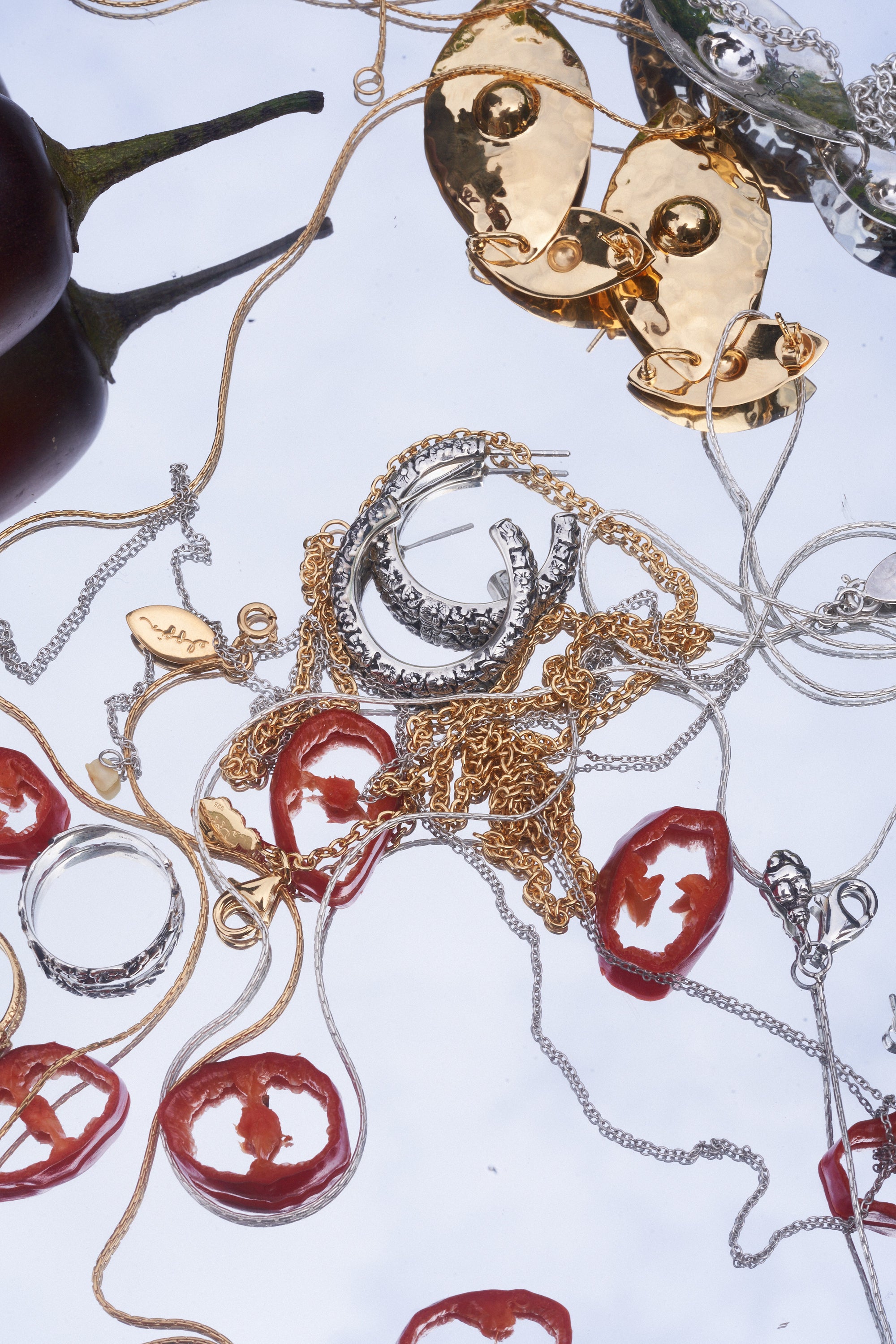 Carina Hardy fine jewelry pieces intertwined with red chili. Luxurious craftsmanship and unique design. View the collection today.