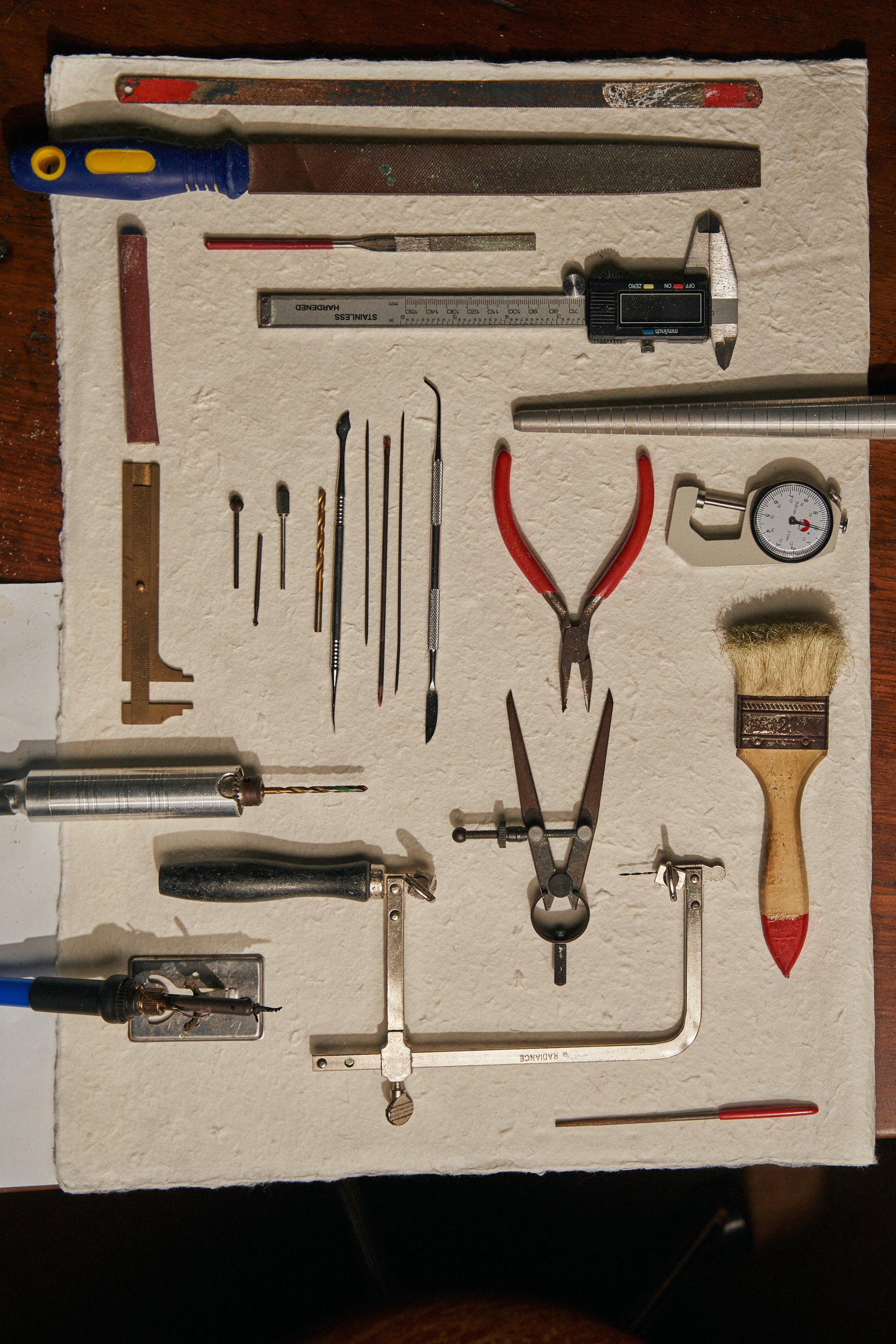 Organized display of jewelry-making tools and materials. The process behind Carina Hardy’s fine jewelry. View the collection today.