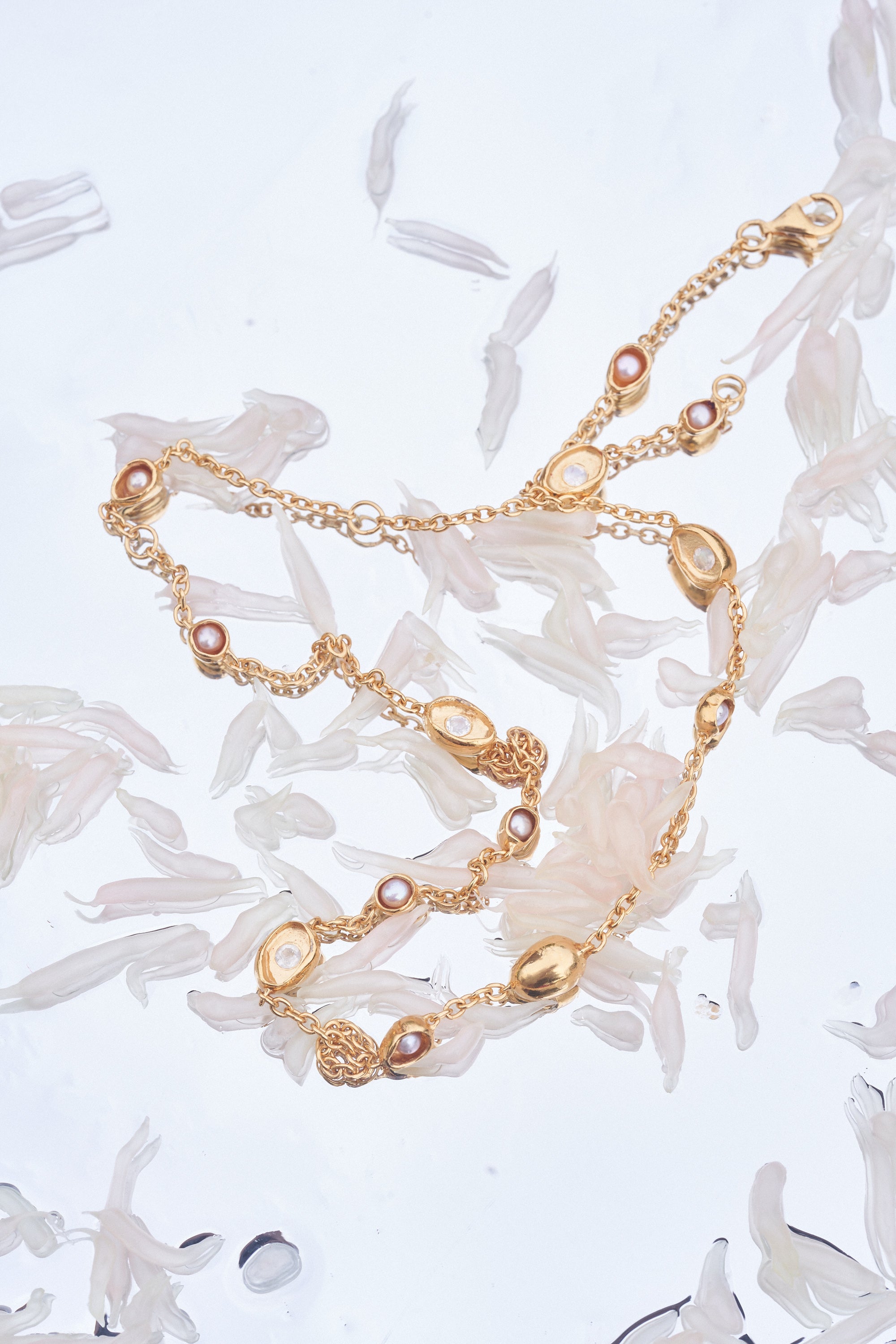 Carina Hardy fine sterling silver gold plated Showers necklace arranged on a delicate background. Intricate design and elegance. View the collection today.